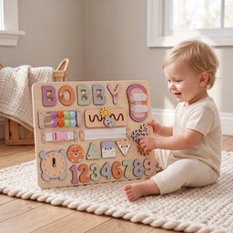 toddler playing with personalized busy board